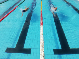 swimmers in lane pool, men in water