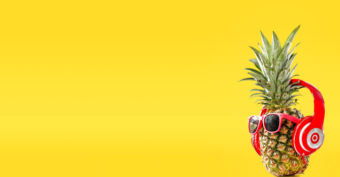 Summer photo of pineapple and yellow background of free space for your text. 