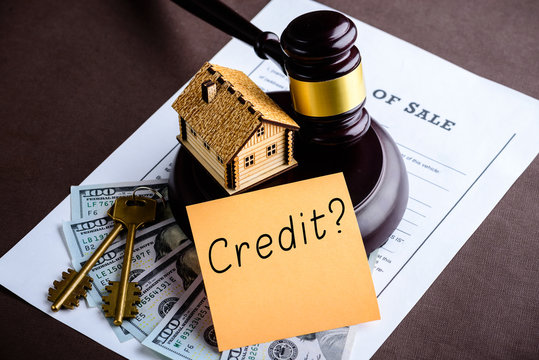 Concept of home loan and credit. Little wooden house, judges gav