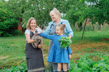 Fototapeta premium Grandmother with kids in the garden