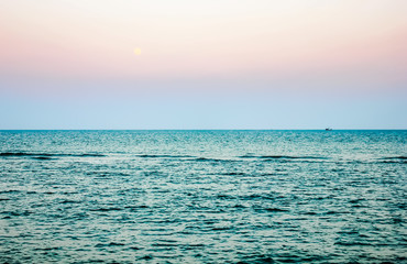 Beautiful sunset over the ocean, Calm Ocean And Blue Clear Sky Seascape Background