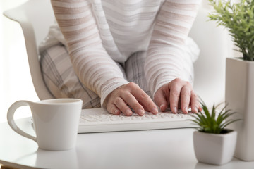 Female hands typing on a keyboard