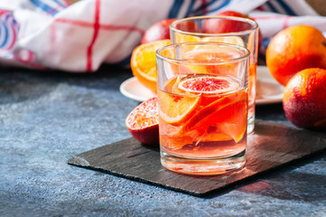 Citrus infused water with slices of fruits. Seasonal beverages concept.
