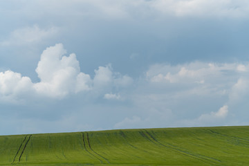 Fototapeta premium Podolia region, Ukraine. Landscape with dramatic clouds over agricultural field