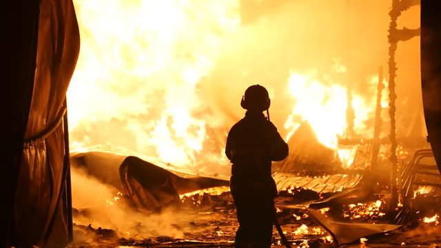 Firefighter In Front Of A Open Fire
