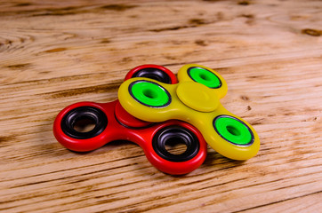 Two fidget spinners on wooden desk