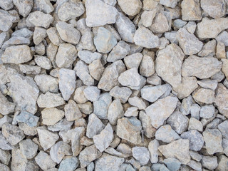 Pile of stones on the construction site. A layer of stone lining under the asphalt.