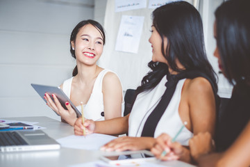 Fototapeta premium Young asian businesswoman working happy smile and relax in office