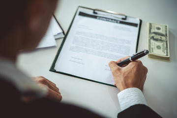 Businessman signing contract for bank money loaning