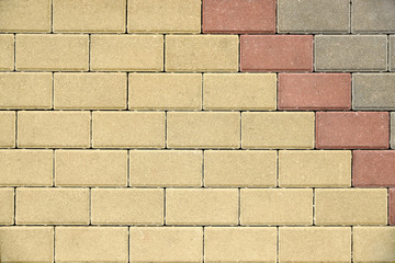 Masonry made of yellow decorative bricks. Paving stone new