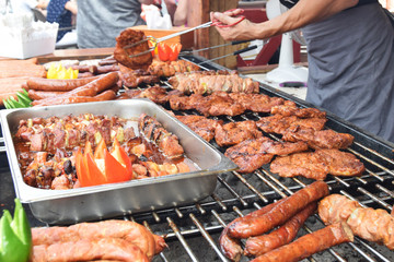 sausage steaks skewers grilled at festivity with peppers