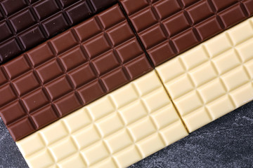 chocolate in diffrent color. milk, dark and white chocolate bars