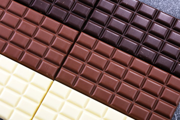 chocolate in diffrent color. milk, dark and white chocolate bars