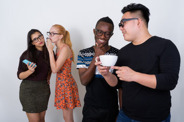 Happy diverse group of multi ethnic friends smiling while having
