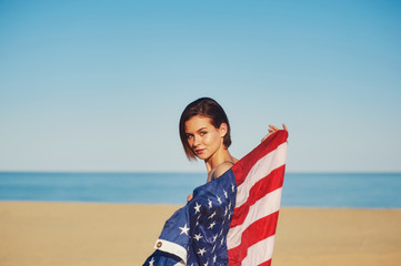 A young woman holding the us flag