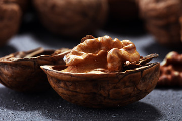 Walnut kernels and whole walnuts on rustic old table