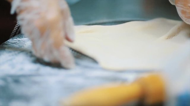 Fresh pizza with meat beaf chicken pork, tomatoes, vegetables, mushrooms. closeup. Process, stages of cooking pizza. juicy, mouth-watering pizza is cut with a metal pizza cutter on wooden background