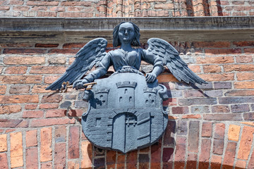 Torun, Poland - medieval arms, emblem of the city above the gate to the town 