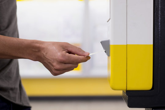 Man Validating His Train Or Subway Ticket