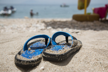 Blue flip-flops on the beach