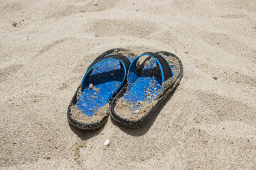 Blue flip-flops on the beach