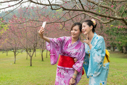 young Asian females taking selfie