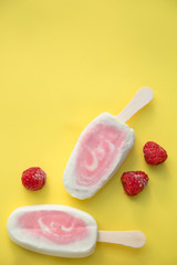 Popsicle with fresh raspberry on a table