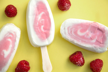 Popsicle with fresh raspberry on a table