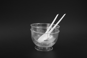 disposable plastic kitchenware on a black background. ice cream bowl.