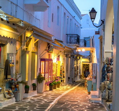 Fototapeta Touristic narrow street with souvenirs shops in the evening