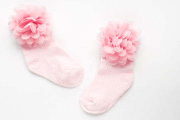 baby pink socks on white background. concept of the birth of a child