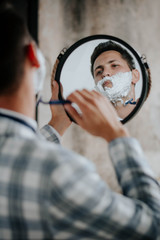 morning routine: a man shaving before going to work.