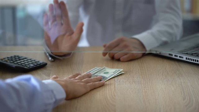 Bank cashier refusing to change dollar banknotes, currency exchange limitations