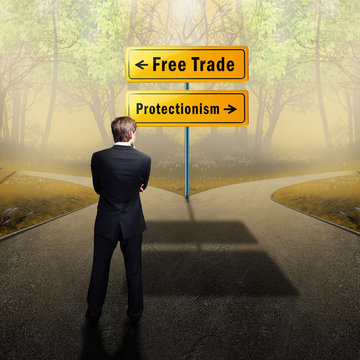 Businessman stands on crossroad between "free trade" and "protectionism"