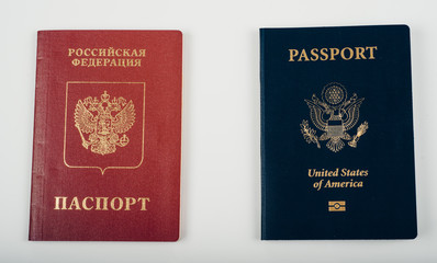 Naklejka premium Red Passport of Russia (Russian Federation) - Cyrillic labels and Blue passpost of USA (United states of America) on white background.