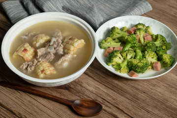 Bone soup with wood grain background