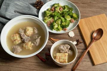 Bone soup with wood grain background