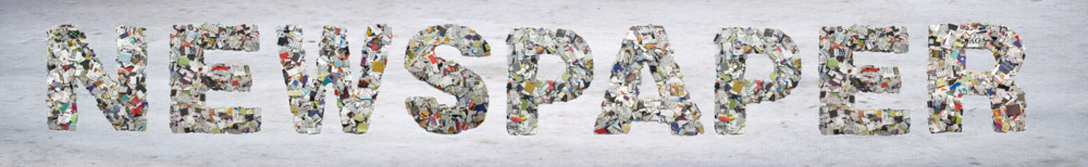 the word    NEWSPAPER made from newspaper confetti on old paper