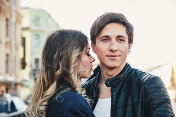 Happy couple is spending vacation holidays in St. Petersburg. Both look really happy. They are strolling along the streets of the old town