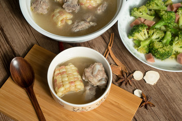 Bone soup with wood grain background