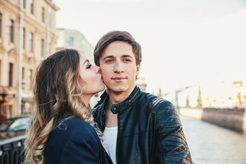 Happy couple is spending vacation holidays in St. Petersburg. Both look really happy. They are strolling along the streets of the old town