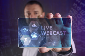 The concept of business, technology, the Internet and the network. A young entrepreneur working on a virtual screen of the future and sees the inscription: Live webcast