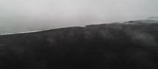 Fototapeta na wymiar aerial view of black sand beach with fog in iceland