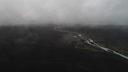 aerial view of black sand beach with fog in iceland