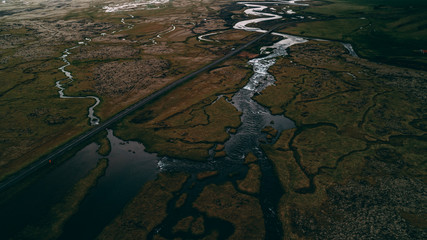 aerial view of river with many junctions and highway