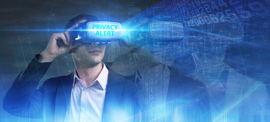 Business, Technology, Internet and network concept. Young businessman working in virtual reality glasses sees the inscription: Privacy alert