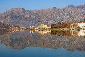 Beautiful symmetrical landscape where mountains and coast are reflected in water. Montenegro, Bay...