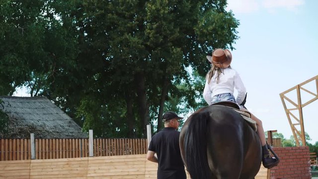 Young pretty girl is on the equestrian sport training. 4K