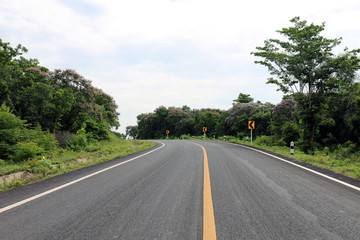Obraz premium road, street, avenue roadway, countryside road and curve traffic signs in the left Thailand