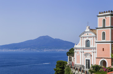 Obraz premium Vico Equense. Italy. La chiesa di Santissima Annunziata, the volcano Mount Vesuvius in the background.